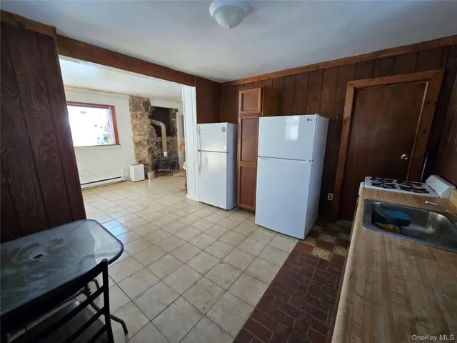 a view of a refrigerator in kitchen and living room