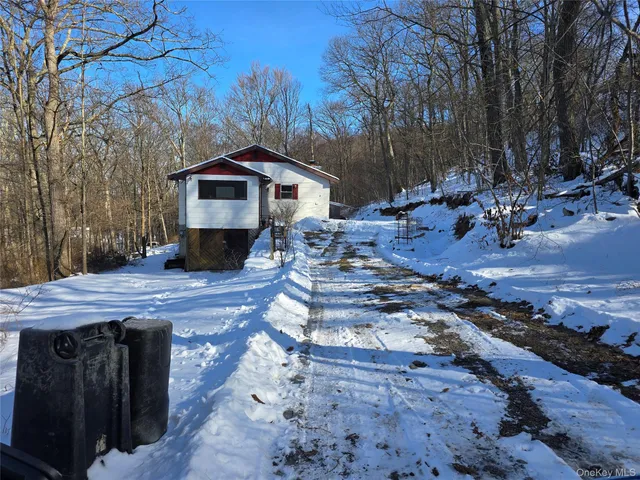 a view of a wooden house with a yard