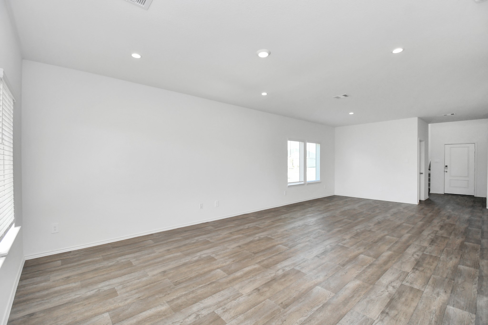 30903 Rockstock Road Fulshear, TX 77441 - Photo 11 of 42 an empty room with wooden floor and window