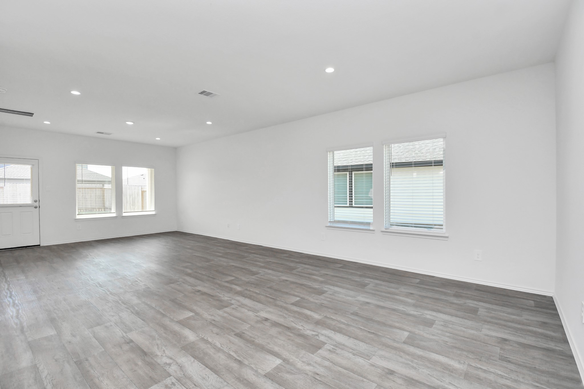 30903 Rockstock Road Fulshear, TX 77441 - Photo 14 of 42 a view of empty room with wooden floor and fan