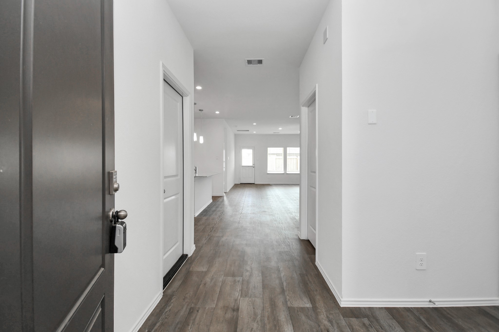 30903 Rockstock Road Fulshear, TX 77441 - Photo 15 of 42 a view of a hallway with wooden floor