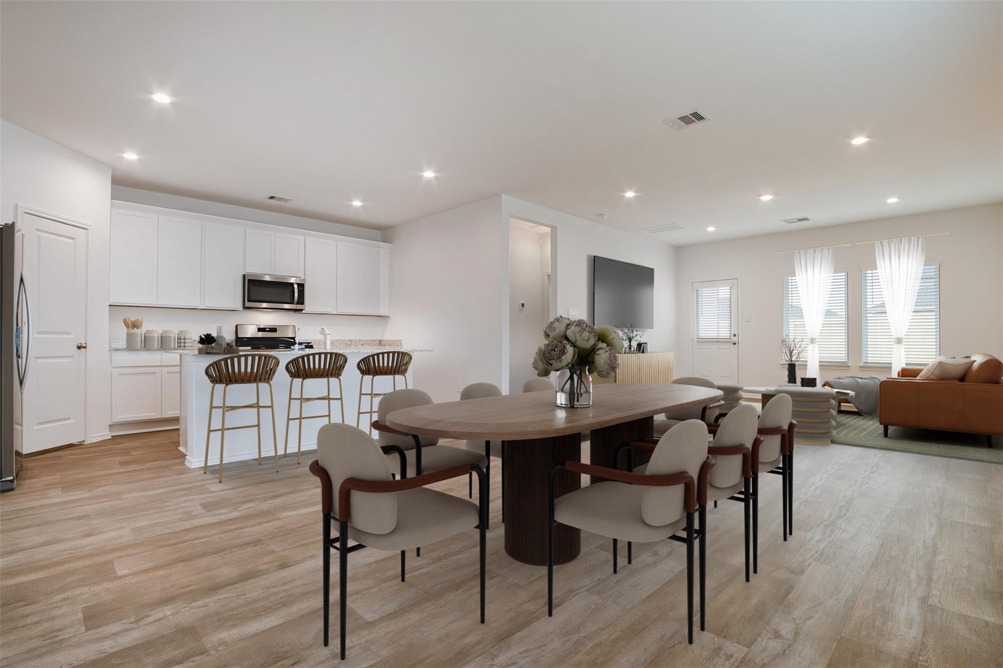 30903 Rockstock Road Fulshear, TX 77441 - Photo 2 of 42 a view of a dining room with furniture and wooden floor