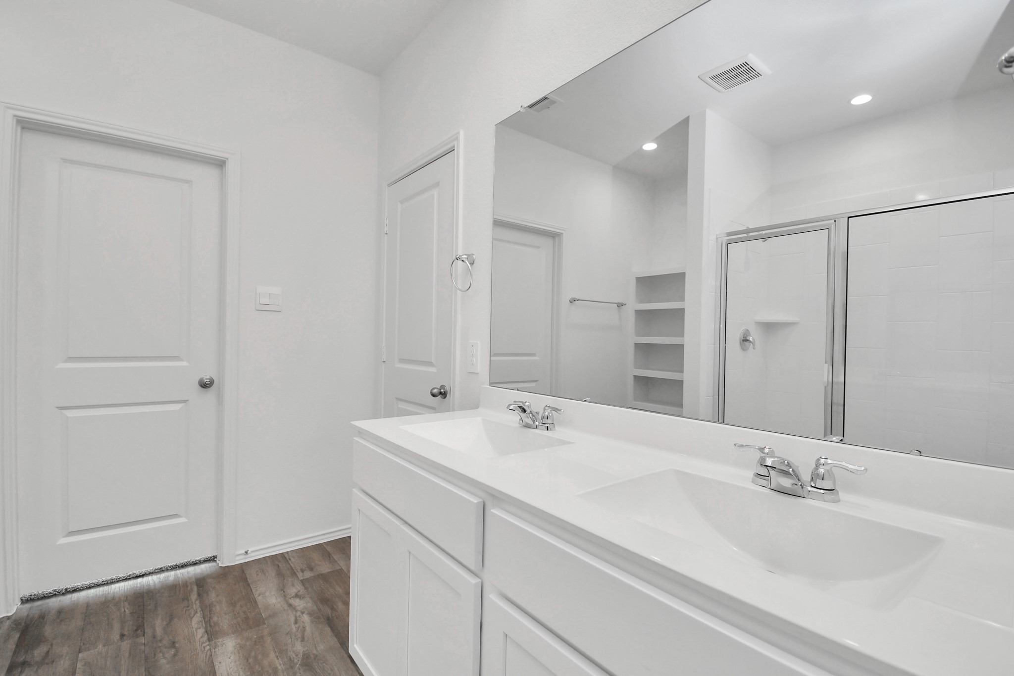 30903 Rockstock Road Fulshear, TX 77441 - Photo 23 of 42 a bathroom with a double vanity sink a mirror and a shower