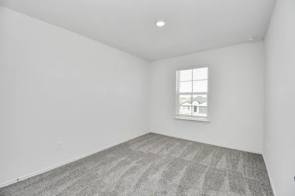 a front view of a house with a yard and a tree