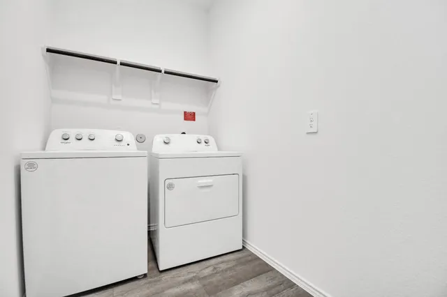 a front view of a house with a yard and a tree