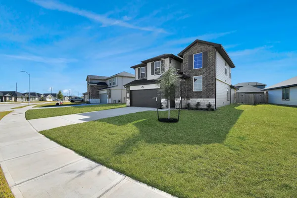 a front view of a house with a yard and garage