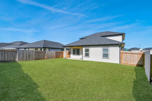 a front view of a house with yard and green space