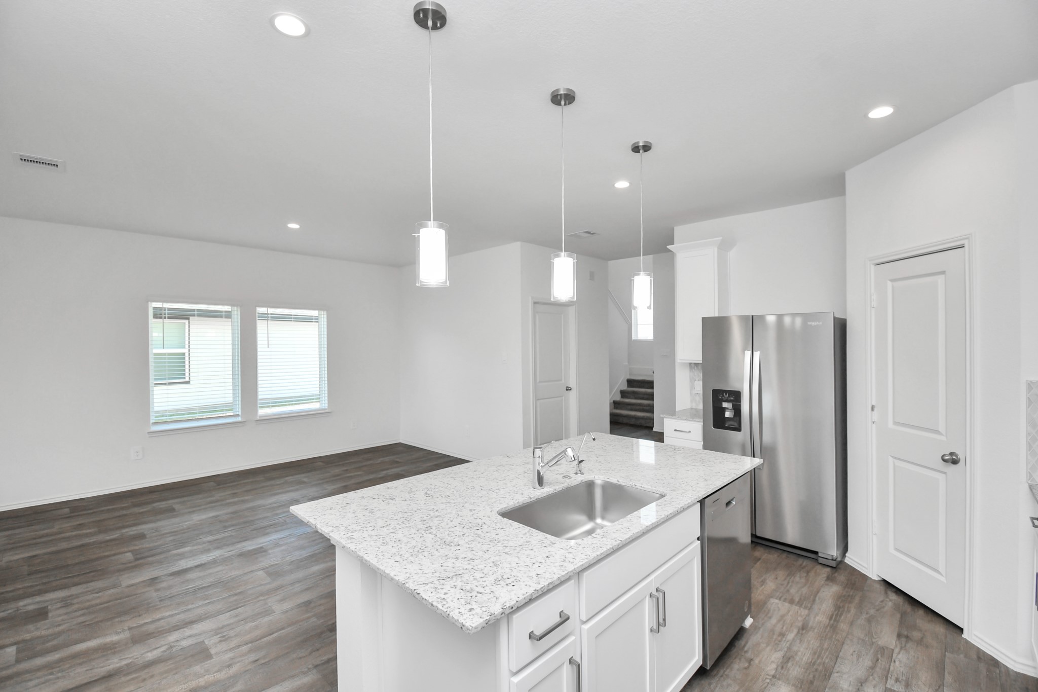 30903 Rockstock Road Fulshear, TX 77441 - Photo 7 of 42 a kitchen with stainless steel appliances granite countertop a sink a refrigerator and a stove