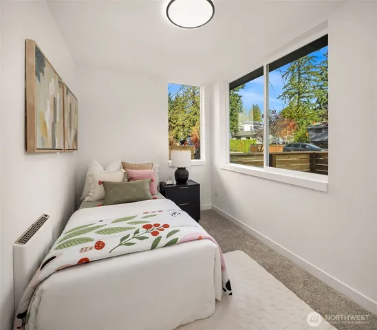 a bedroom with a bed and a large window