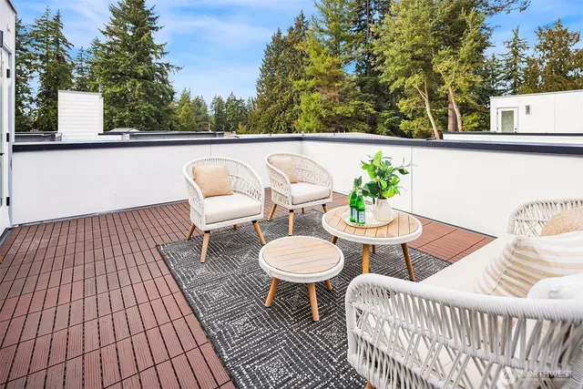 a balcony with table and chairs