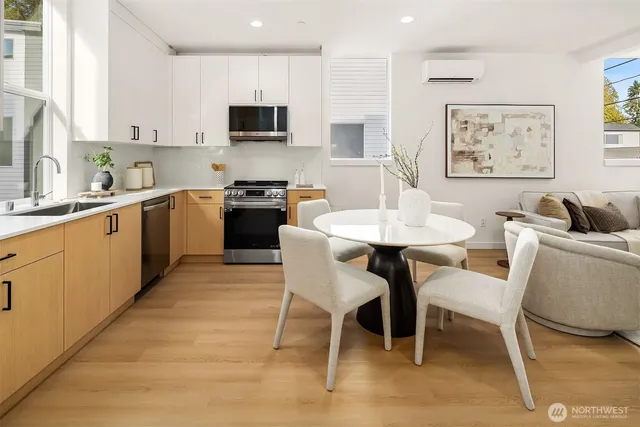 a kitchen with a dining table chairs and a sink