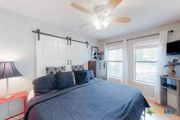 a bedroom with a large bed and a window