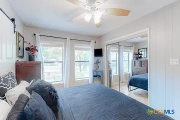 a bedroom with a bed and glass door