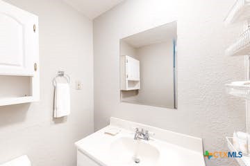 510 Cypress Ridge Road McQueeney, TX 78123 - Photo 19 of 32 a bathroom with a sink and a mirror