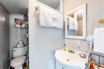 510 Cypress Ridge Road McQueeney, TX 78123 - Photo 24 of 32 a bathroom with a sink mirror and toilet