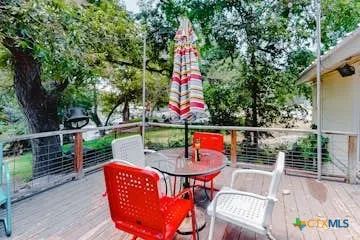 an outdoor sitting area with couch and wooden fence