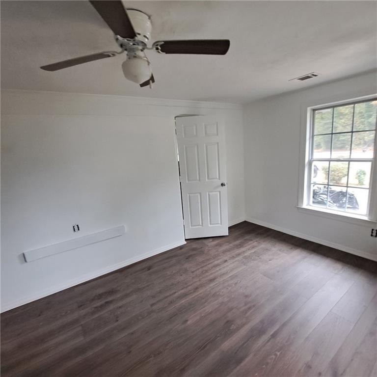 2174 Whites Mill Road Decatur, GA 30032 - Photo 11 of 11 a view of an empty room with wooden floor and a window