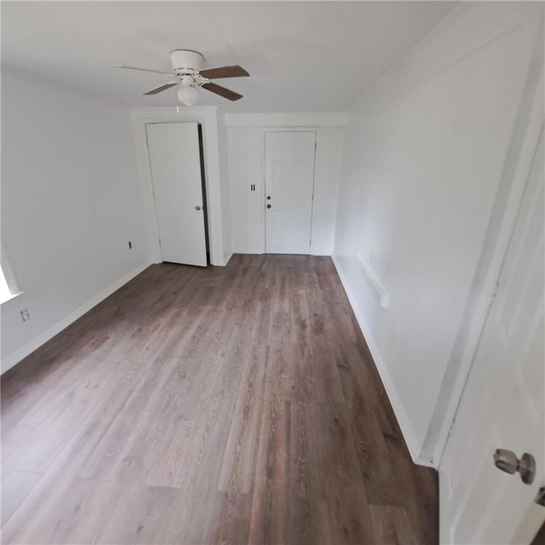 2174 Whites Mill Road Decatur, GA 30032 - Photo 2 of 11 a view of a room with wooden floor and ceiling fan