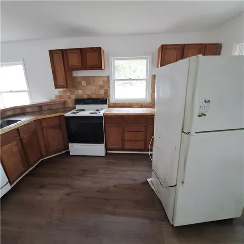 a kitchen with a refrigerator and a sink
