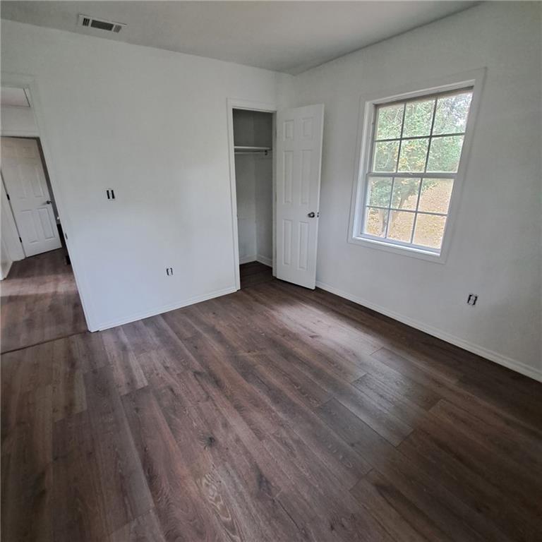 2174 Whites Mill Road Decatur, GA 30032 - Photo 7 of 11 an empty room with wooden floor and windows