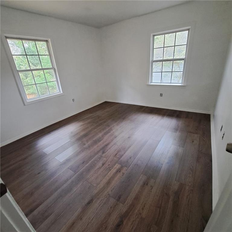 2174 Whites Mill Road Decatur, GA 30032 - Photo 8 of 11 an empty room with wooden floor and windows
