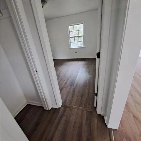 wooden floor in a hall with a window