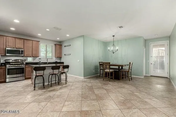 a kitchen with kitchen island granite countertop a sink a counter top space appliances and a window