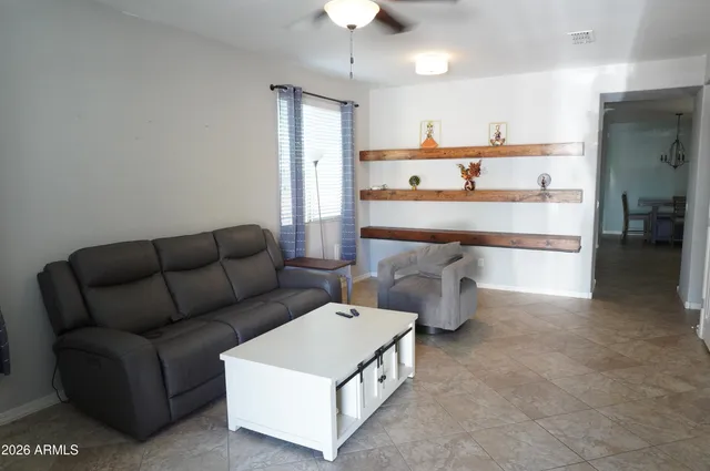 a living room with furniture and a chandelier