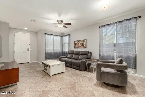 a living room with furniture and a chandelier