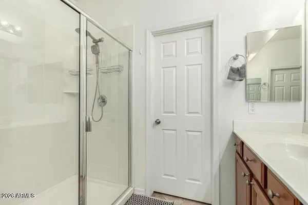 a bathroom with a shower and a sink