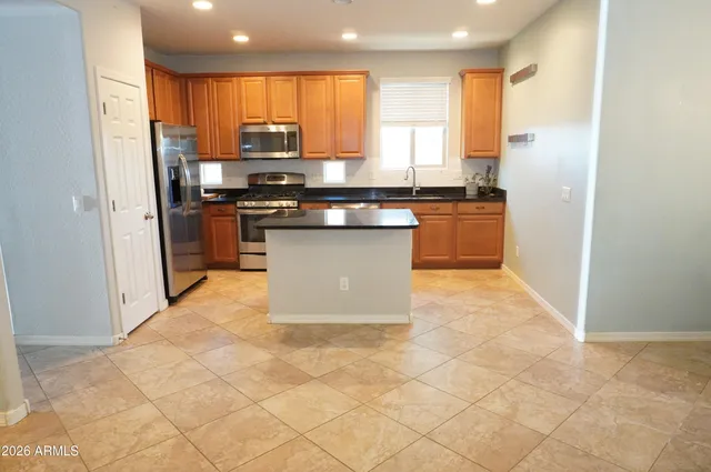 a kitchen with stainless steel appliances cabinets a sink and a counter top space