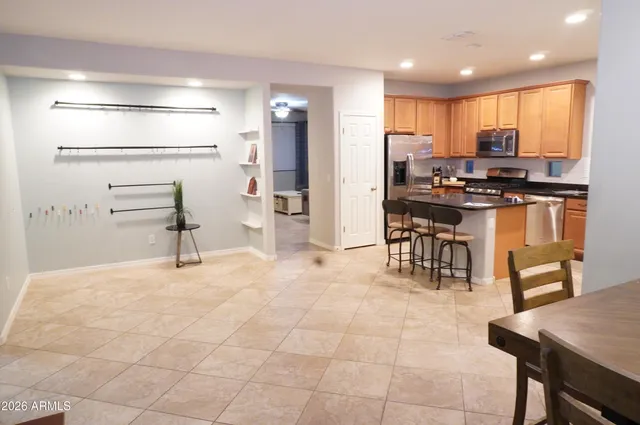 a kitchen with stainless steel appliances kitchen island granite countertop a refrigerator and cabinets