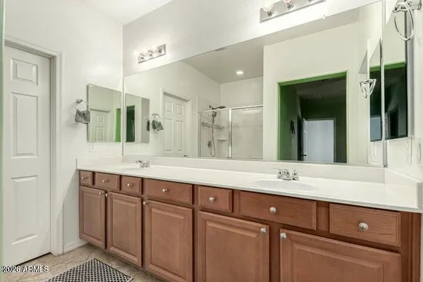a bathroom with a sink double vanity and a mirror