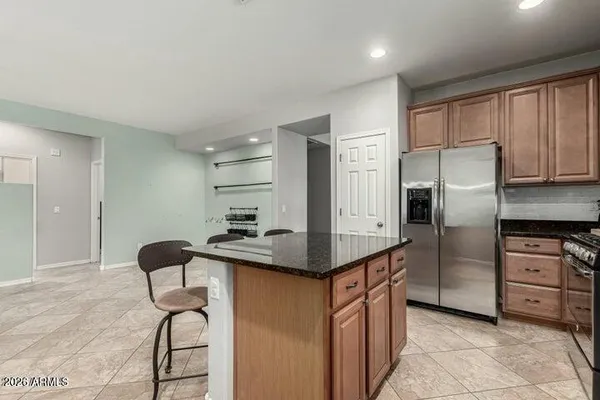 a kitchen with stainless steel appliances granite countertop a sink refrigerator and microwave