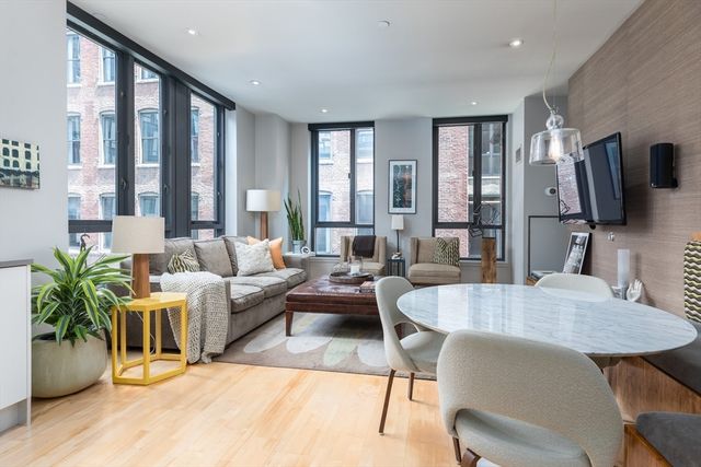 a living room with furniture wooden floor and a flat screen tv