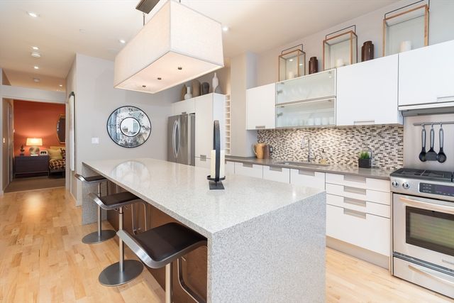 a kitchen with cabinets and wooden floor