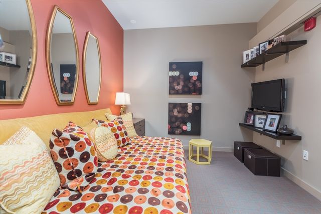 a bedroom with a bed and a television