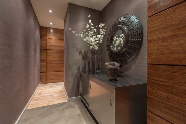 a bathroom with a sink a light fixture and a glass door