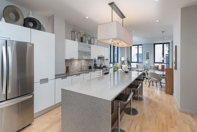 a kitchen with counter space a sink appliances and cabinets
