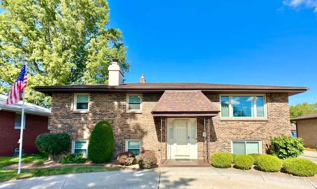 a front view of a house with a garden