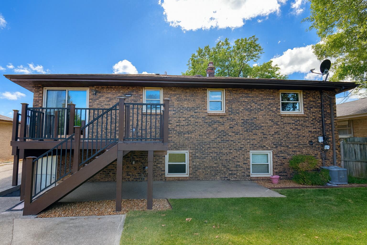 3631 Manor Drive Highland, IN 46322 - Photo 2 of 30 a brick house with a large tree in the background