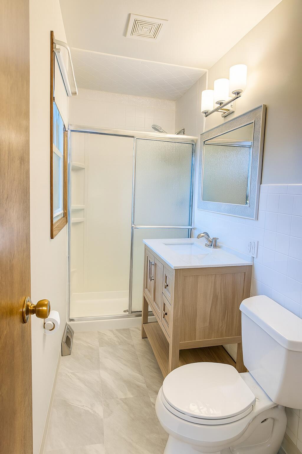 3631 Manor Drive Highland, IN 46322 - Photo 10 of 30 a bathroom with a sink a mirror a toilet and a shower