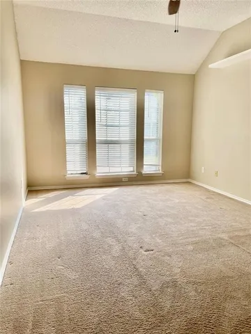 an empty room with a empty space and windows