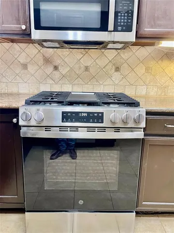 a kitchen with a stove and cabinets