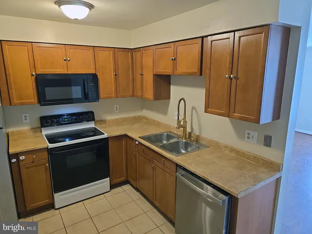 a kitchen with a refrigerator stove and microwave
