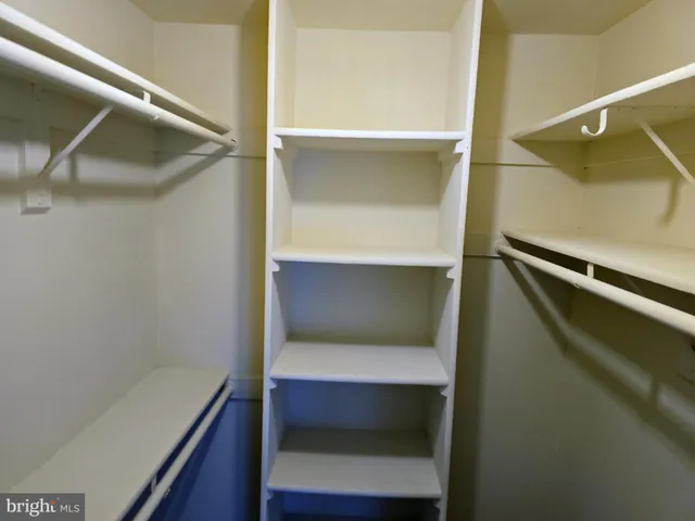 a view of a room with wooden floor and a window