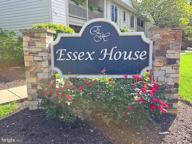 a view of a street with a brick wall