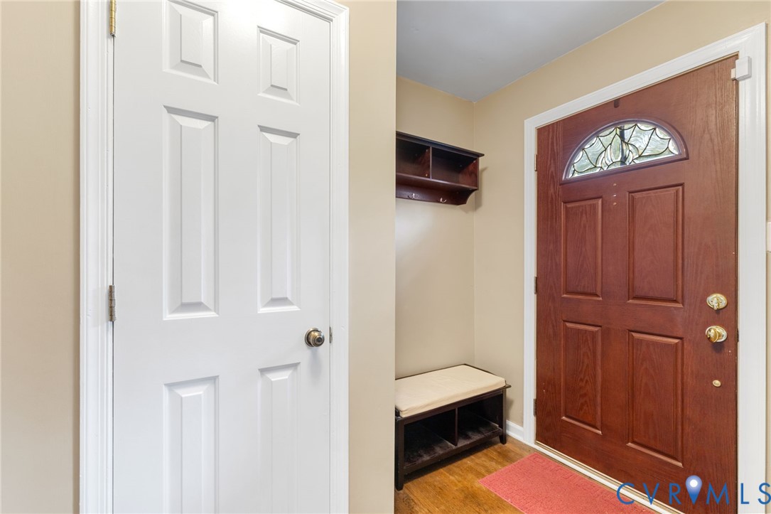 Mudroom with wood finished floors and baseboards