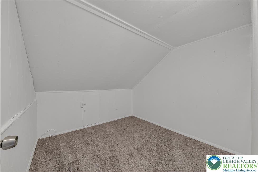 313 Main Street Slatington, PA 18080 - Photo 60 of 73 A cozy, sloped-ceiling room with soft carpeting offers versatile living space.
