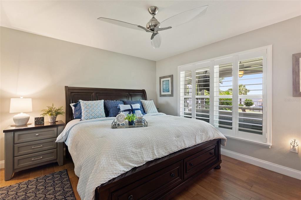 1395 South Lake Reedy Boulevard Frostproof, FL 33843 - Photo 28 of 81 a bedroom with a bed a dresser and a chandelier